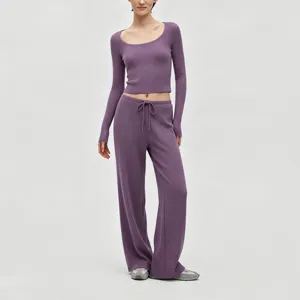 Detailed view of the purple ribbed knit long sleeve crop top and wide leg pants set.