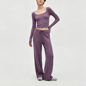 Detailed view of soft ribbed knit texture on purple crop top and wide leg pants outfit.