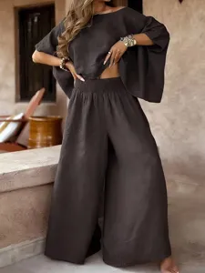 Detail shot of casual solid color loose round neck off-shoulder summer women two piece outfit.