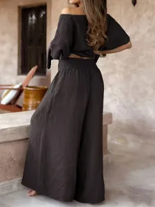 Detailed view of the back side of a solid color off-shoulder top and wide leg pants set.