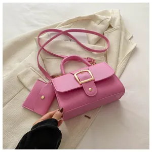 Pink fashion shoulder handbag with top handle and small pouch detail for women daily use.
