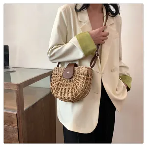 Woven straw crossbody bag for women, stylish summer saddle bag with leather flap closure.