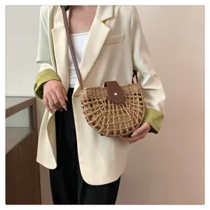 Woven straw crossbody bag detail showing texture, perfect for summer beach and vacation.