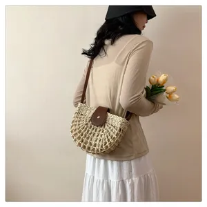 Woven straw saddle bag for women, summer beach crossbody handbag with brown leather flap.