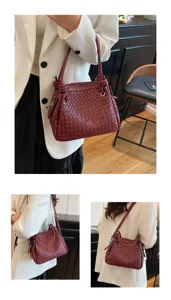 Detailed view of woven leather shoulder bag showing craftsmanship, rich burgundy color.