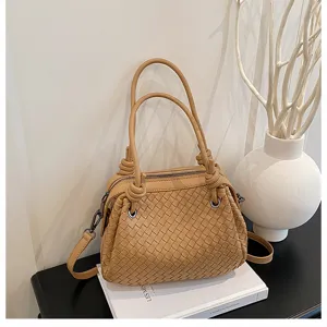 Caramel woven leather handbag featuring unique knot handles and detailed craftsmanship.