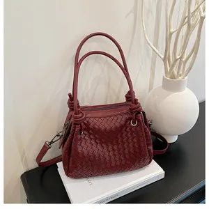 Burgundy woven leather shoulder handbag for women, elegant knot handle design with crossbody strap.