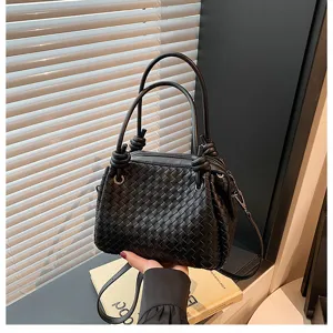 Black woven leather tote bag with metal buckle, stylish shoulder bag for women daily use.
