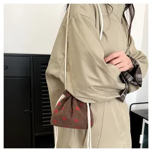 Corduroy strawberry print drawstring bucket shoulder bag detail for women winter fashion trend