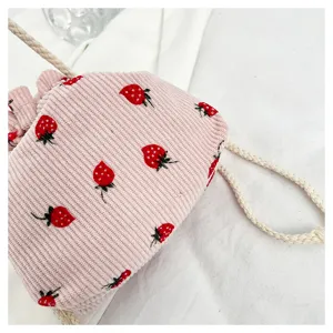 Strawberry corduroy bucket bag detail close-up showing cute pink fabric and sweet fruit print.