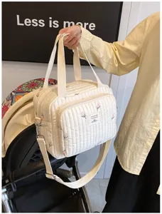 Bolso cambiador acolchado con bordado de tulipanes, gran compartimento y correa ajustable.
