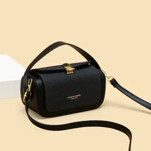 Stylish black crossbody handbag for women with gold hardware and top handle for daily use.
