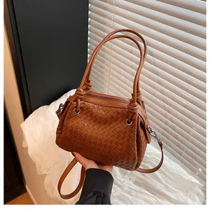 Brown woven leather tote bag with stylish knot handle and metal rings for women daily use.