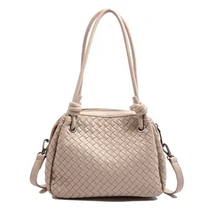 Woven leather shoulder handbag for women, large capacity stylish tote bag with knotted handles.