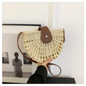 Woven straw saddle bag for women, summer beach cross-body bag with PU leather flap.
