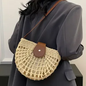 Woven straw crossbody bag for women, stylish summer beach saddle bag with brown leather flap.