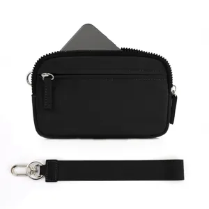 Detail view of black nylon wristlet pouch with strap and phone pocket for daily use