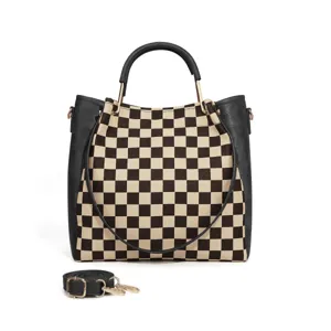 Black and white checkerboard tote bag with black leather trim, top handles, and crossbody strap.