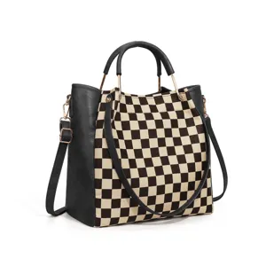 Detailed view of the chic checkerboard canvas shoulder handbag with black leather trim and gold hardware.
