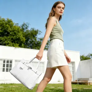 Detailed view of the elegant white structured handbag, showcasing premium texture and clasp.