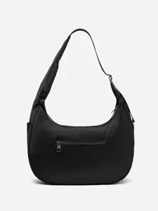 Detailed view of black nylon crescent crossbody bag with adjustable strap and front zipper.