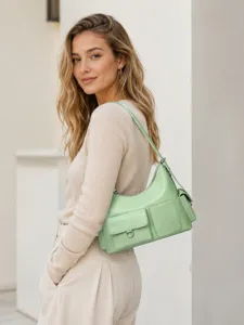 Detailed view of the stylish light green shoulder bag with multiple pockets and chic design.