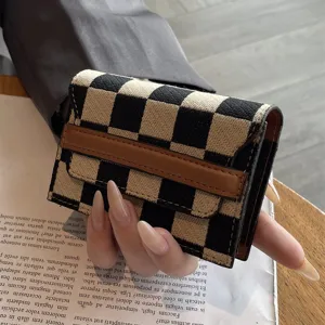 Detailed shot of a chic black and beige checkered card holder, compact and stylish minimalist design.