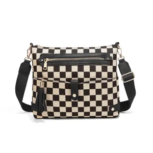 Black and white checkerboard canvas crossbody bag with wide strap, zipper pocket and tassels.