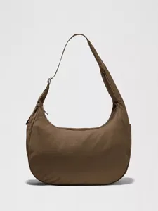 Detail view of the brown nylon crescent shoulder bag, featuring a large capacity and adjustable strap.