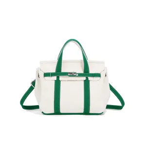 Canvas handbag detail, green and white contrast, top handle, adjustable strap, daily use.