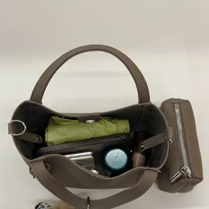 Retro litchi grain PU bucket handbag with detachable pouch, spacious interior design.