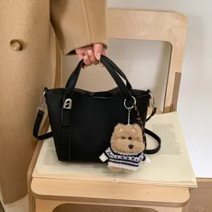 Retro litchi PU bucket bag with cute bear pendant, stylish handbag and messenger bag.