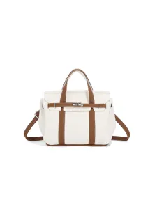 Small contrast color canvas handbag with top handle and adjustable crossbody strap.