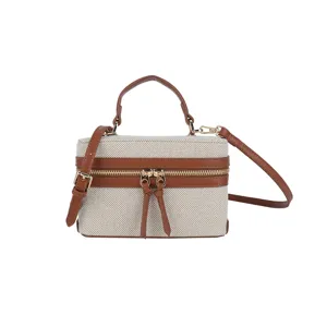Details of the retro canvas box bag with contrast brown leather trim and metal hardware