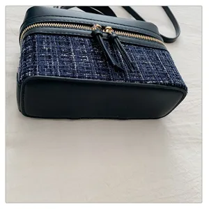 Chic tweed vanity bag with leather trim and gold zipper for stylish women daily use.