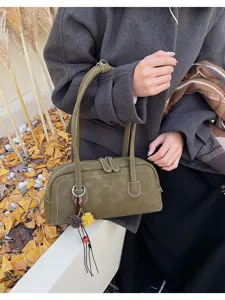 Classic olive green retro baguette shoulder bag for women, stylish vintage handbag with tassels.
