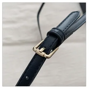 Detailed shot of a stylish leather handbag strap with durable metal buckle for daily wear.