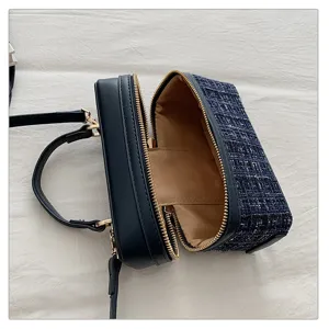 Close-up detail of blue tweed box handbag, vintage style structured crossbody bag design.