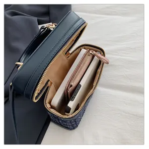 Detailed view of structured tweed box handbag interior capacity showing lining and zipper pocket.