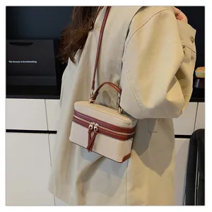 Close-up detail of stylish retro color-block canvas vanity box handbag with leather handle.