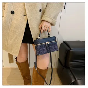 Classic tweed vanity box bag with top handle and shoulder strap for women, elegant style.