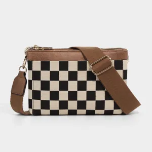 Black and white checkerboard canvas crossbody bag with brown pu trim and adjustable strap.