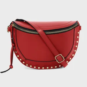 Stylish red crescent sling bag featuring gold-tone studs and adjustable strap for women.