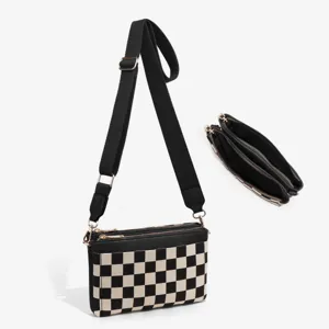 Black and white checkerboard canvas shoulder bag detail view showing multi zippers strap.