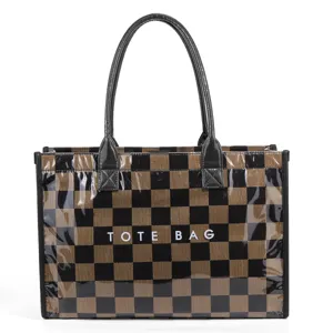 Detail shot of black-brown checkerboard PVC tote bag with double handles and front text.