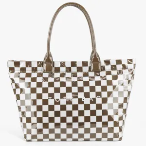 Brown and white checkerboard tote bag detail showing glossy PVC texture and double handles.