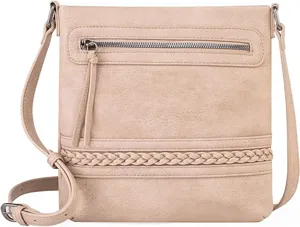 Crossbody bag detail showing front zipper pocket, braided texture and adjustable strap.