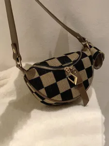 Stylish checkerboard canvas crossbody bag with small earphone pouch and brown strap for women daily commute.