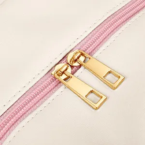Close-up detail of lunch bag double gold zipper pulls with pink zipper tape for durability.