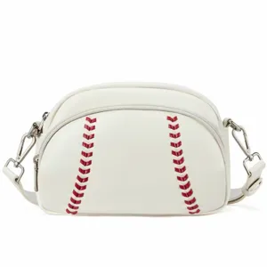 Detailed view of white leather baseball shaped crossbody bag with red stitching and zipper.